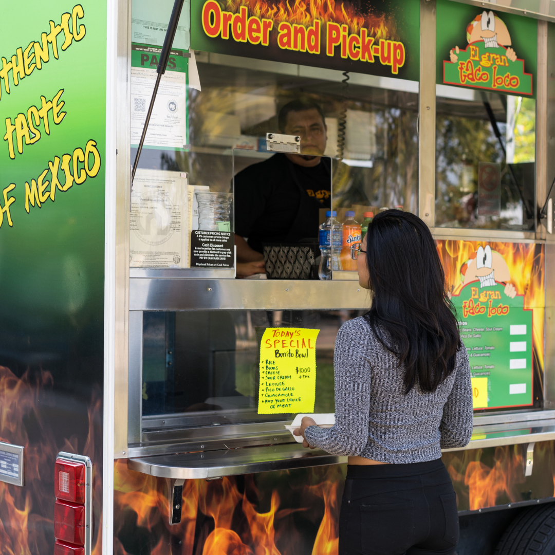 Customer ordering at the taco truck window.
